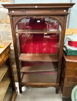 A narrow Edwardian mahogany full height display cabinet enclosed by single door on square legs, 4