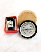 A circular vintage Swedish Fahrenheit thermometer in original box; a STOWA miniature wind up clock/