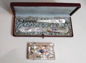 A mother of pearl and abalone shell decorated card case; a boxed mother of pearl letter opener and