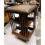 An Edwardian mahogany revolving bookcase with brass gallery