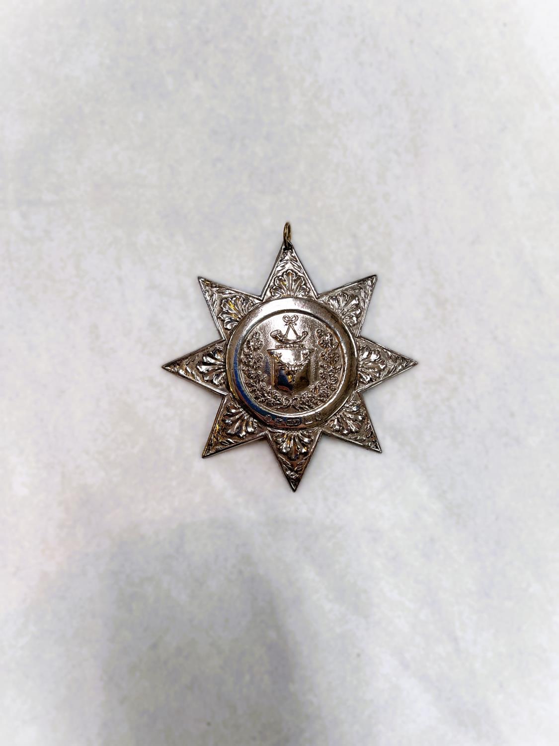 A hallmarked silver star shaped sash buckle, Ancient Order of Foresters, Hilliard & Thomason,