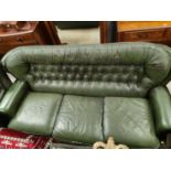 A three seater leather effect Chesterfield style leather three seater settee in green, deep button