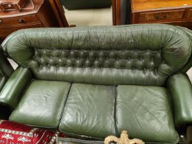 A three seater leather effect Chesterfield style leather three seater settee in green, deep button