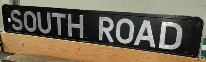 A metal South Road sign and a Water Methanol sign