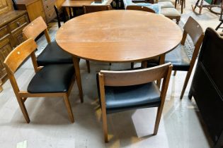 A mid 20th century teak dining table, circular form with drop leaves and a set of 6 matched teak
