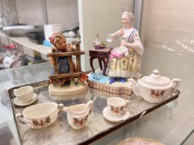 A 19th century Dresden/Meissen style group:  lady taking tea, crossed swords mark; a Hummel figure;