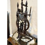 A stained hard wood Folk Art spinning wheel with bone mounts and inlay, bearing plaques "Luise