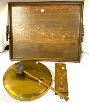 A brass wall mounted gong; a coat hook; a 1930's oak tray