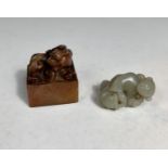 A Chinese jade coloured hardstone carving of a figure with a basket, and a hardstone seal.