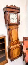 An early 19th century oak and mahogany longcase clock with architectural pediment and turned columns