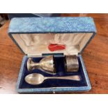 A hallmarked silver cased christening set with egg cup, napkin ring and spoon