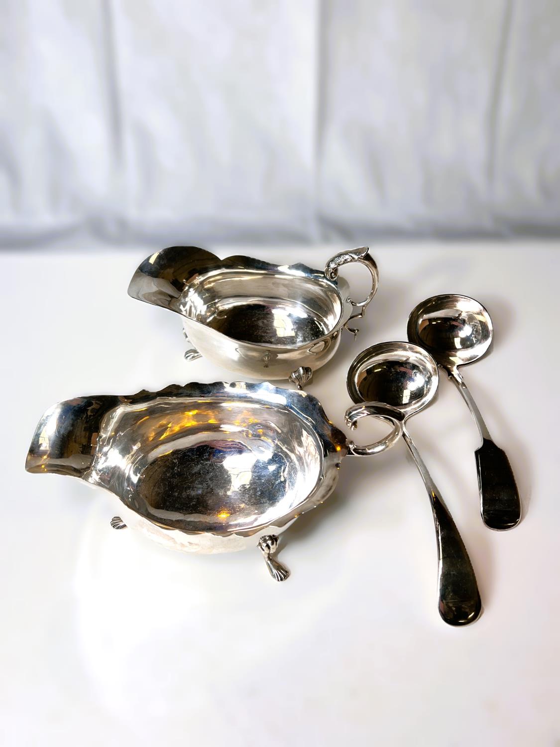 A matching pair of hallmarked silver sauce boats with cut rims and triple paw feet, Birmingham - Image 2 of 3