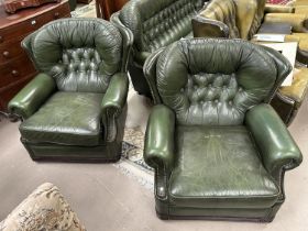 A pair of green leather effect Chesterfield style armchairs with deep button back and studded