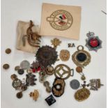 A quantity of British army cap badges, buttons etc