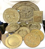 A good collection of brass traditional wall plaques, circular and shield shaped; a collection of