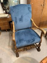 An early mid 20th century high back period style armchair in buttoned blue fabric