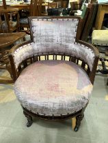 An Edwardian mahogany low seat tub armchair in pink fabric