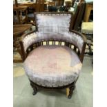 An Edwardian mahogany low seat tub armchair in pink fabric