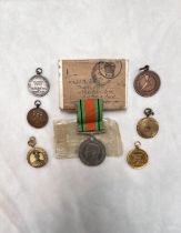 A 1939/45 Defence medal in original package, photo pendants, dancing medals
