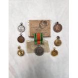 A 1939/45 Defence medal in original package, photo pendants, dancing medals