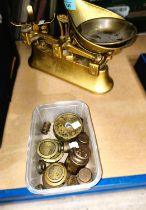 A set of brass and cast metal kitchen scales and a selection of weights