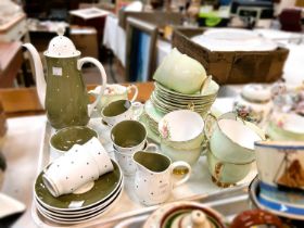 A Susie Cooper coffee service with various colours and spots; an Art Deco floral service, a Queen