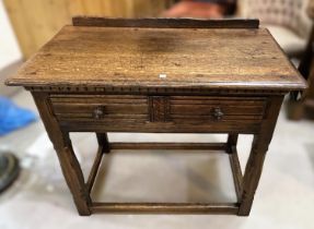 A distressed oak side table, Georgian style in the manner of Titchmarsh & Goodwin with frieze