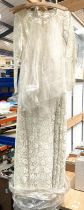 A 20th century lace wedding dress with veil; a sewing box and contents