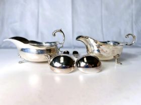 A matching pair of hallmarked silver sauce boats with cut rims and triple paw feet, Birmingham