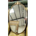 An early 20th century gilt metal framed mirror in the Rococo style with beaded decoration to the rim