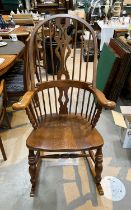 A 20th century country style stick and fiddle back rocking arm chair