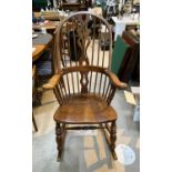 A 20th century country style stick and fiddle back rocking arm chair