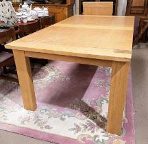 A light oak extending dining table with square legs, extended length 302cm