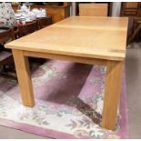 A light oak extending dining table with square legs, extended length 302cm