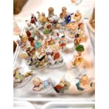 A collection of continental miniature porcelain figures of children
