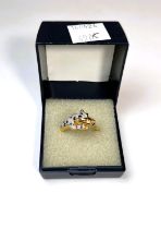 An 18ct gold dress ring in the form of tiger set with diamond chips and sapphires, with green