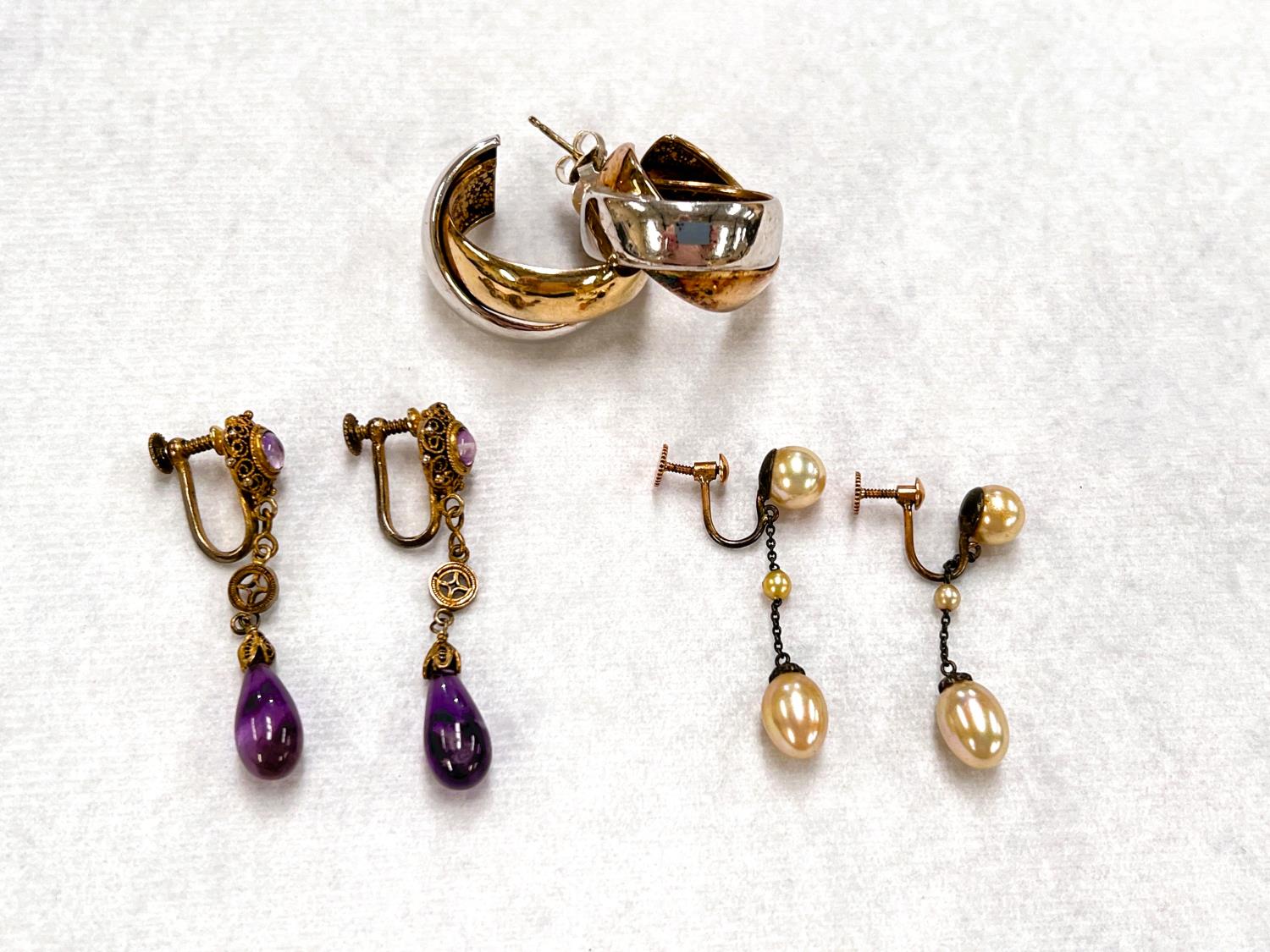 A vintage pair of screw earrings with amethyst 'tear' drops and pink moonstone effect stones; a pair