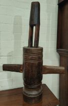 An antique wooden French grape masher