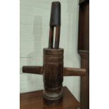 An antique wooden French grape masher