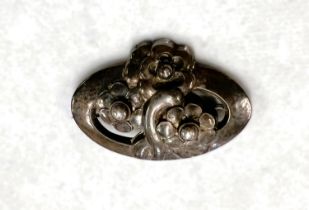 Georg Jensen:  a silver pierced oval brooch with 3 flowers, stamped Georg Jensen Sterling Denmark No