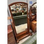 A Victorian mahogany framed cheval mirror with arch top and reeded side supports, on plinth base,