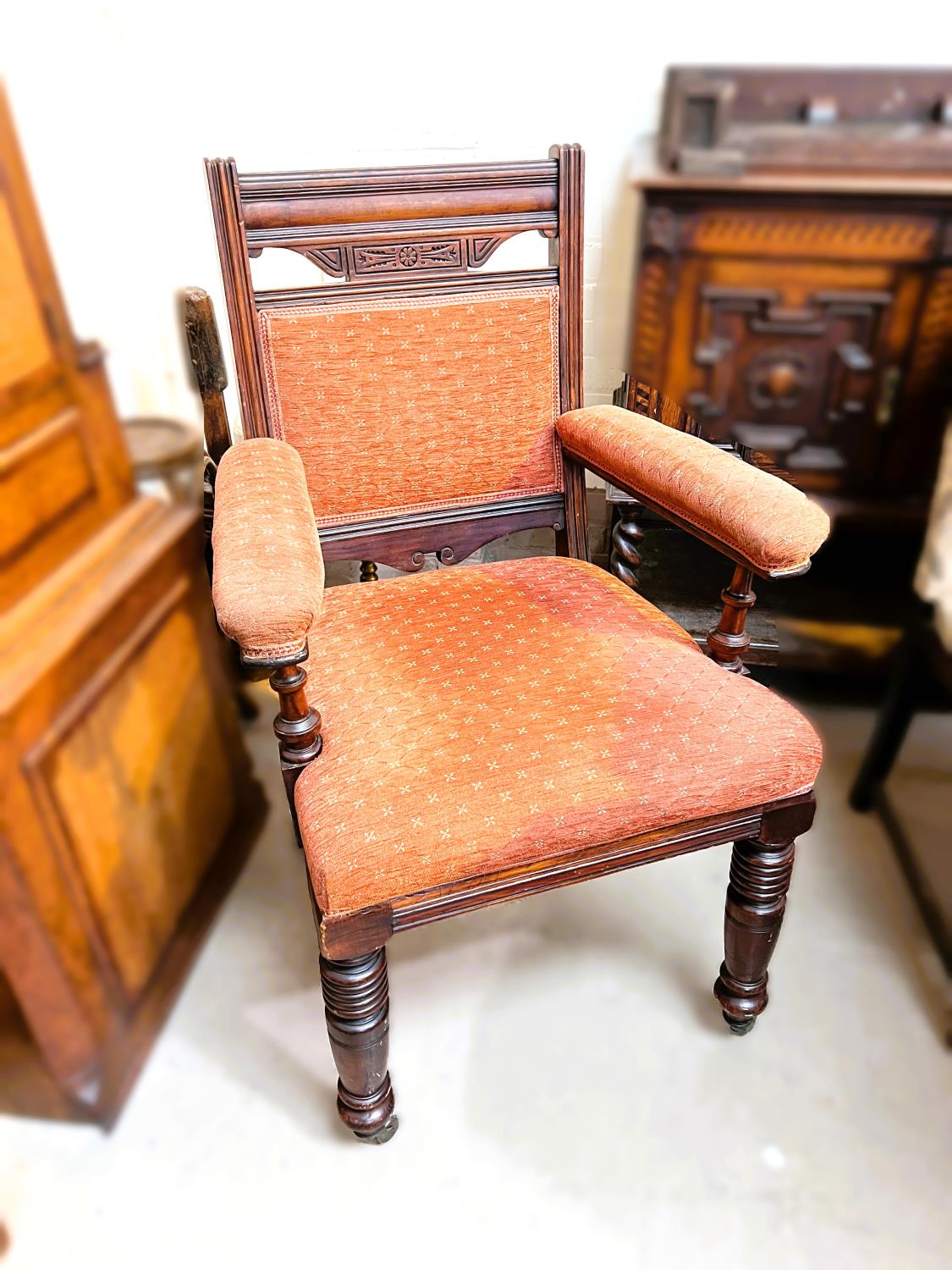 A pair of Edwardian arm chairs, aesthetic movement look, cushioned upholstery