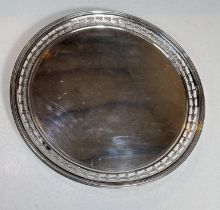 A hallmarked silver circular salver with pierced border, on raised feet, London 1909, diameter 26cm,