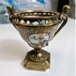 A Chinese bowl in brass pedestal mount with cherub handles and stepped foot, height 14cm (