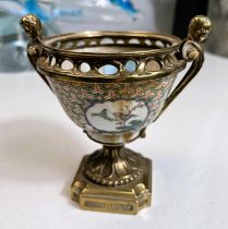 A Chinese bowl in brass pedestal mount with cherub handles and stepped foot, height 14cm (