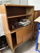 A 1950's bookcase/side cabinet with open shelves and cupboard under