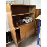 A 1950's bookcase/side cabinet with open shelves and cupboard under