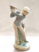 A Lladro figure of a young male golfer, impressed 4024, height 28cm