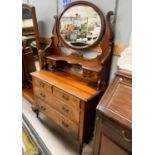 A walnut dressing chest with two long and two short drawers with jewellery drawers