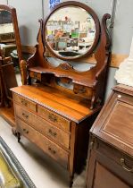 A walnut dressing chest with two long and two short drawers with jewellery drawers